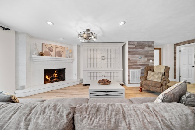 living room with hardwood / wood-style flooring and a fireplace