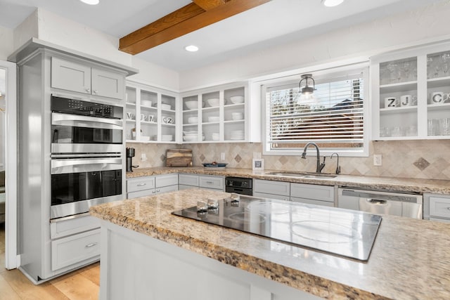 kitchen with gray cabinets, appliances with stainless steel finishes, sink, and backsplash