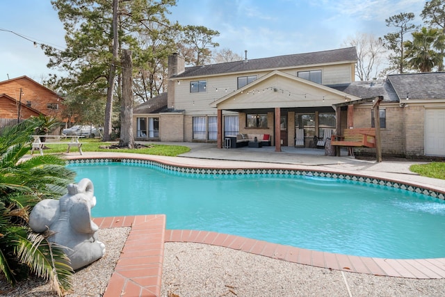 view of swimming pool featuring an outdoor living space and a patio