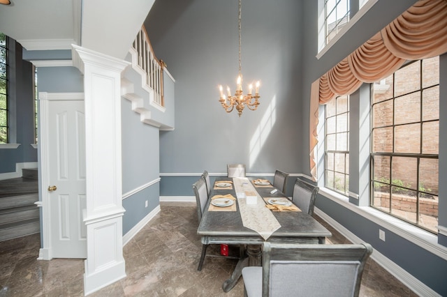 dining area featuring a chandelier and ornate columns