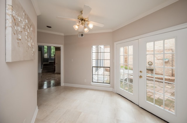 entryway with french doors, ceiling fan, and ornamental molding