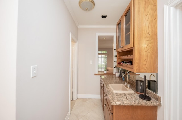 kitchen with crown molding, sink, light tile patterned flooring, and light stone counters