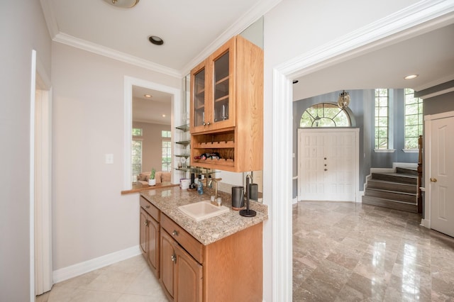 bar with sink, crown molding, and light stone countertops