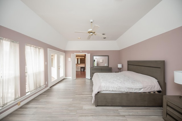 bedroom featuring light hardwood / wood-style flooring, vaulted ceiling, french doors, and ceiling fan