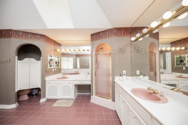 bathroom featuring vanity, tile patterned flooring, and a shower with door