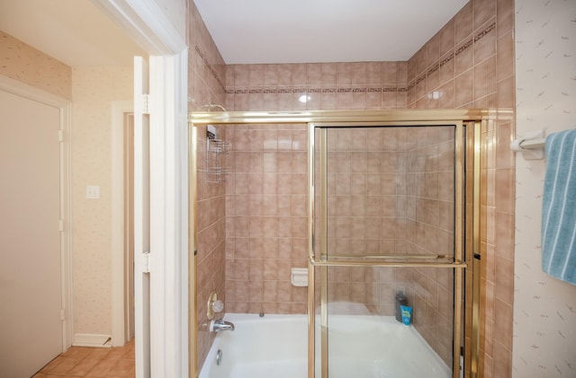 bathroom with tile patterned flooring and combined bath / shower with glass door