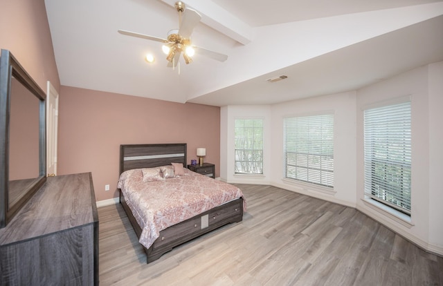 bedroom featuring ceiling fan, vaulted ceiling, and light hardwood / wood-style flooring