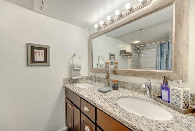 bathroom featuring vanity and a shower with shower curtain