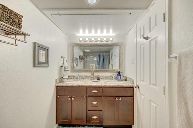 bathroom featuring vanity and a shower with shower curtain