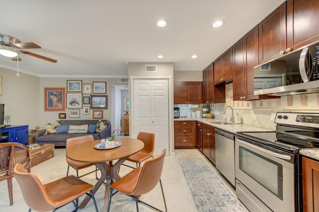 kitchen featuring sink, tasteful backsplash, light stone counters, ornamental molding, and appliances with stainless steel finishes