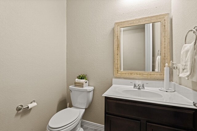 bathroom featuring vanity and toilet