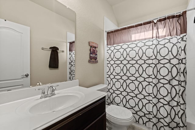 bathroom featuring walk in shower, vanity, and toilet