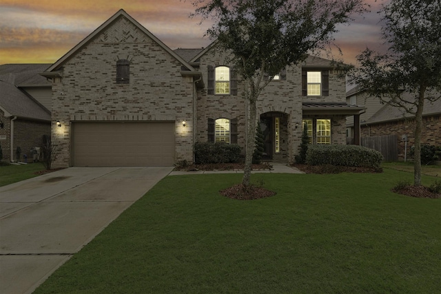 view of front of property with a yard and a garage