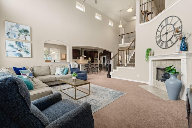 living room featuring a tiled fireplace and light carpet