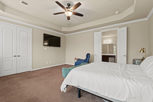 bedroom featuring crown molding, carpet, connected bathroom, and a tray ceiling