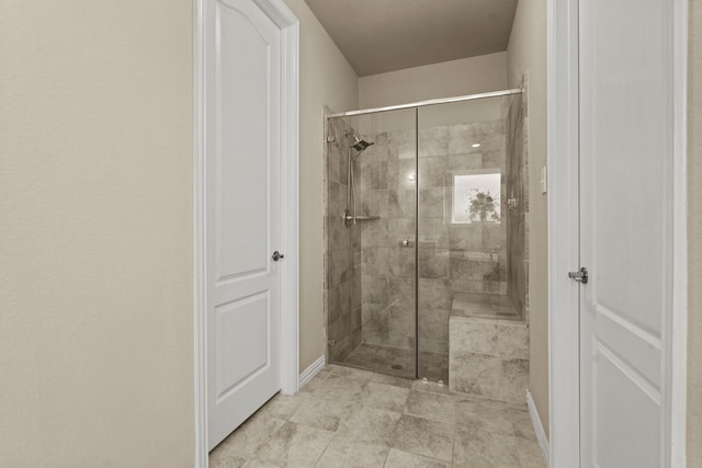 bathroom featuring a shower with door