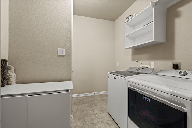 laundry room featuring light tile patterned floors and independent washer and dryer