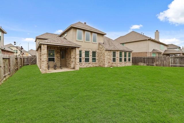 back of property featuring a lawn and a patio area