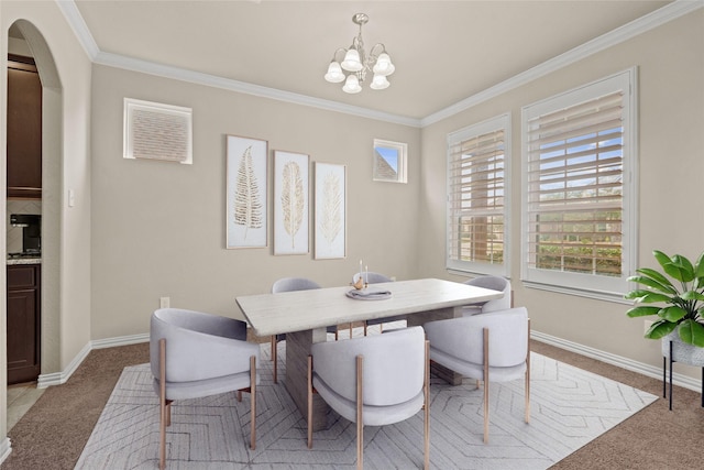 dining room featuring an inviting chandelier, crown molding, and light carpet