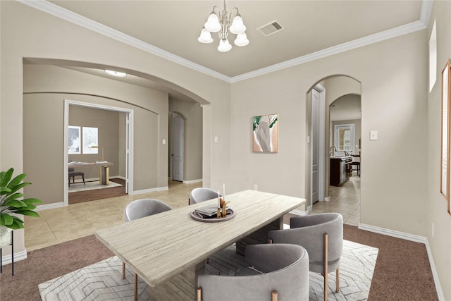 dining space with an inviting chandelier, crown molding, and light carpet