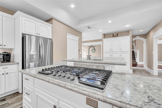 kitchen featuring white cabinetry and appliances with stainless steel finishes