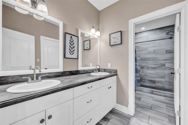 bathroom featuring vanity and a tile shower