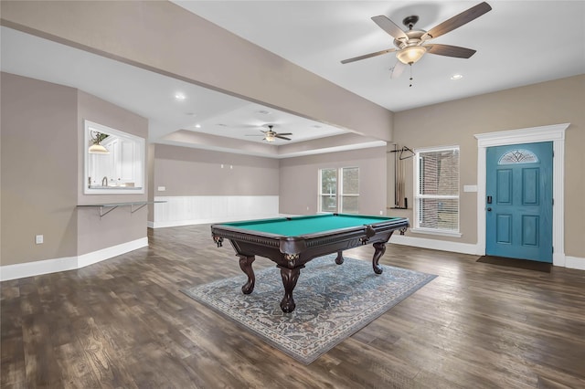 game room with dark wood-type flooring, pool table, a raised ceiling, and ceiling fan