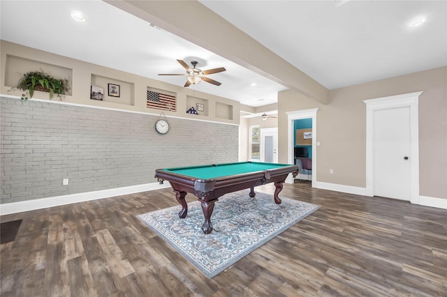 game room with ceiling fan, beam ceiling, brick wall, dark hardwood / wood-style flooring, and pool table