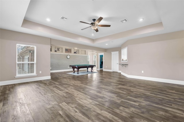 playroom featuring dark wood-type flooring, billiards, ceiling fan, and a tray ceiling