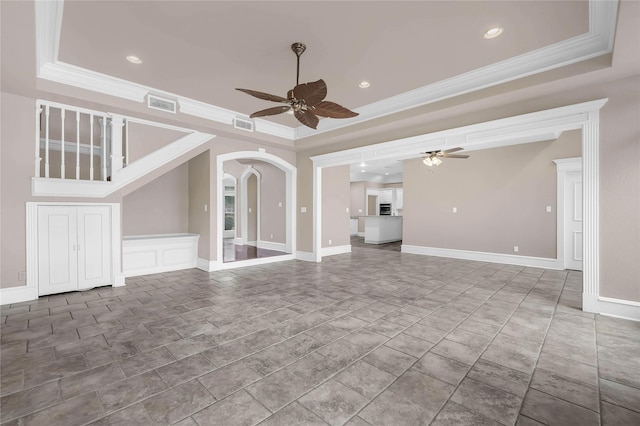 unfurnished living room with crown molding, ceiling fan, and a tray ceiling