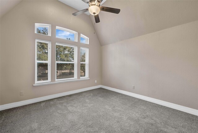 empty room featuring ceiling fan, carpet floors, and vaulted ceiling