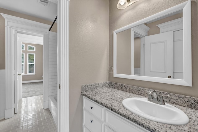 bathroom with vanity, tile patterned flooring, and bathing tub / shower combination