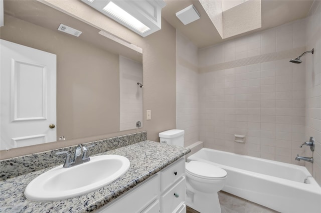 full bathroom with tile patterned floors, vanity, toilet, and tiled shower / bath combo