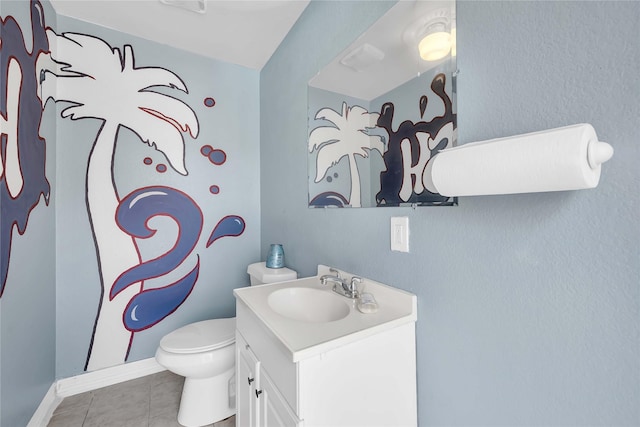 bathroom featuring vanity, tile patterned floors, and toilet