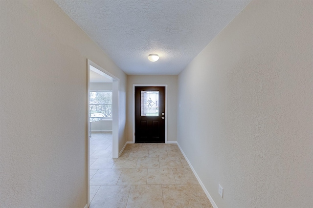 doorway featuring a textured ceiling and light tile patterned floors