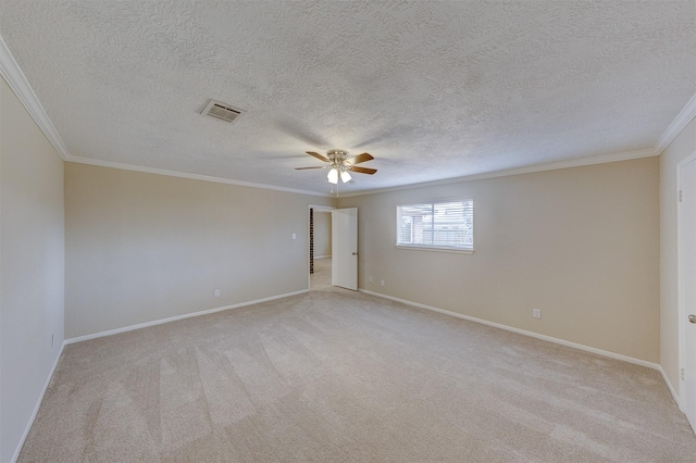 carpeted spare room featuring crown molding, a textured ceiling, and ceiling fan