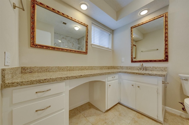 bathroom featuring vanity, tile patterned floors, and toilet