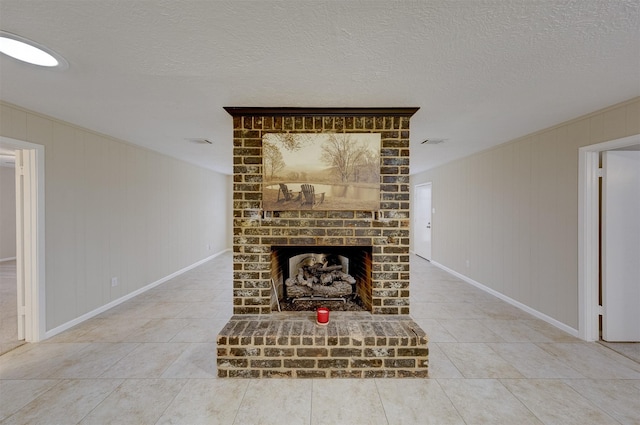 unfurnished living room with a brick fireplace, light tile patterned floors, and a textured ceiling