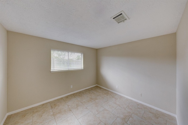 unfurnished room featuring a textured ceiling