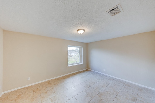 spare room with a textured ceiling