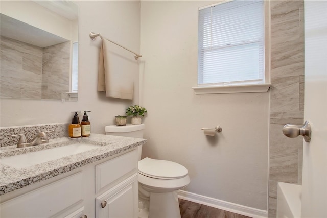 bathroom with vanity, toilet, and wood-type flooring