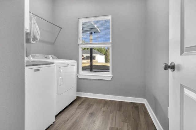 laundry room with independent washer and dryer and light hardwood / wood-style flooring