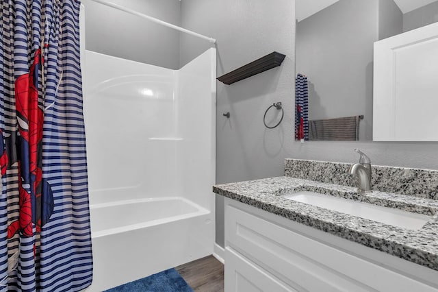 bathroom featuring vanity, wood-type flooring, and shower / bath combination with curtain