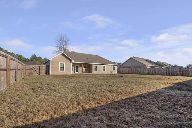 rear view of property with a yard