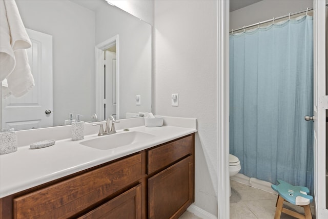 bathroom featuring tile patterned flooring, vanity, and toilet