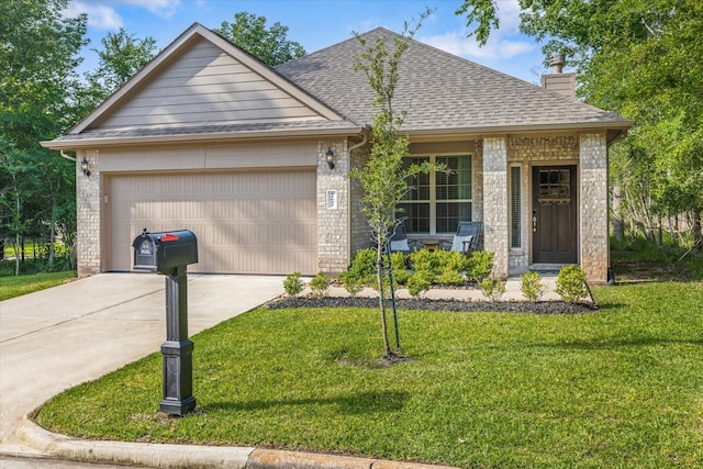 view of front of home featuring a garage and a front yard