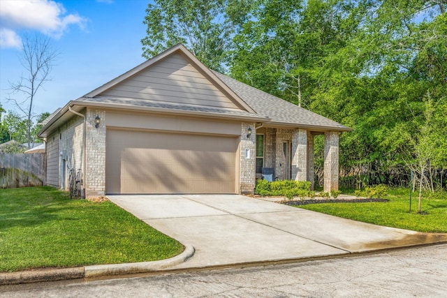 view of front of house with a garage and a front lawn