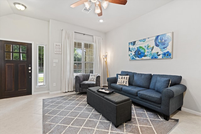 tiled living room featuring ceiling fan and vaulted ceiling