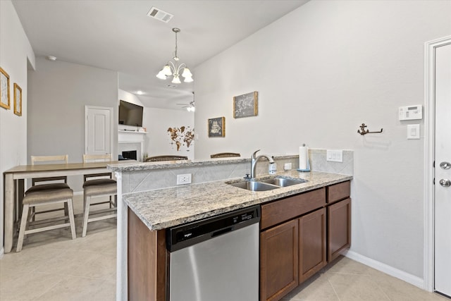 kitchen featuring light tile patterned flooring, decorative light fixtures, dishwasher, sink, and ceiling fan