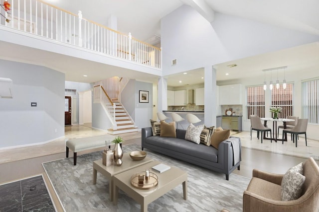 living room with a high ceiling and an inviting chandelier